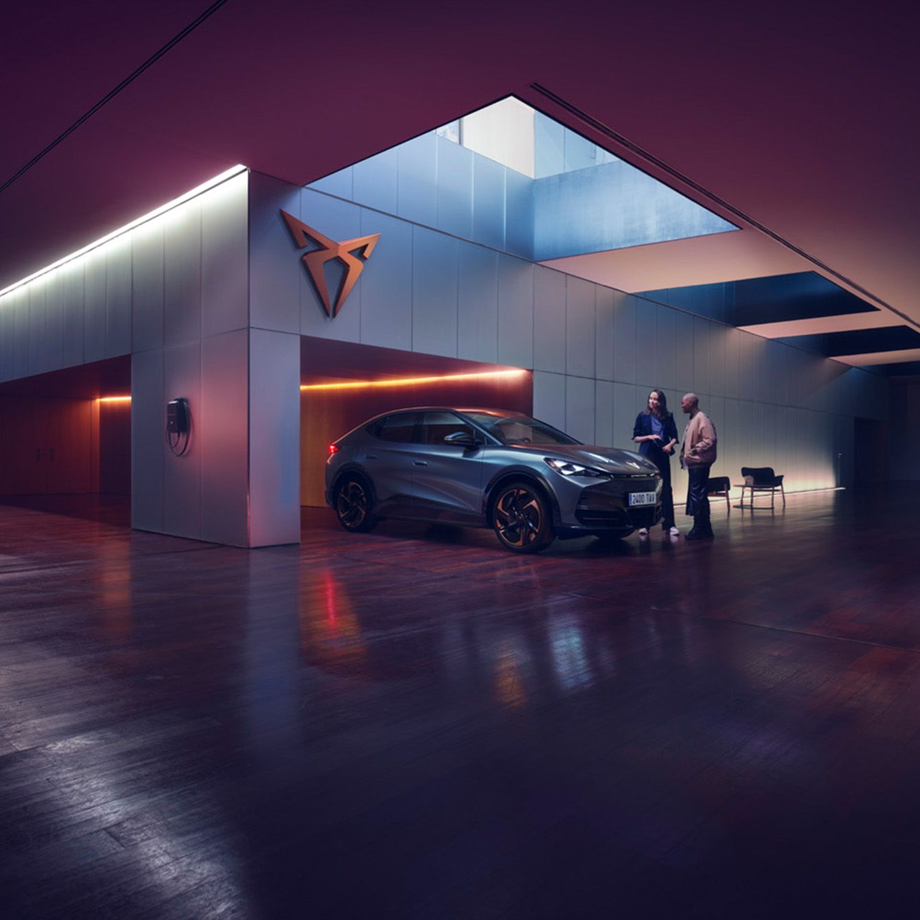 a cupra dealership with a hybrid vehicle parked inside, as two individuals engage in a conversation regarding servicing and maintenance. A modern dealership environment with ambient lighting.